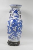 A Chinese blue and white dragon vase, with wood stand, 17" high, 6 character mark to base