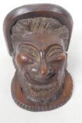 A small C19th carved oak wall bracket carved as a leprechaun head, 5" long, 4¼" wide