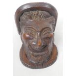 A small C19th carved oak wall bracket carved as a leprechaun head, 5" long, 4¼" wide