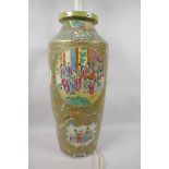 A tall Chinese Canton famille rose cylindrical vase decorated with panels of many figures in