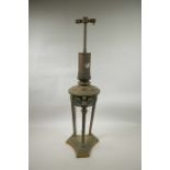 A late C19th/early C20th brass oil lamp with green enamelled reservoir on a triform base,