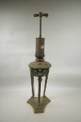 A late C19th/early C20th brass oil lamp with green enamelled reservoir on a triform base,