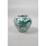A Chinese porcelain ginger jar and cover with green enamelled decoration of a dragon chasing the