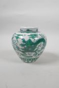 A Chinese porcelain ginger jar and cover with green enamelled decoration of a dragon chasing the