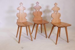 A set of three Gothic style oak hall chairs, 36" high