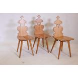 A set of three Gothic style oak hall chairs, 36" high