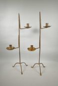 A pair of wrought iron two branch candlesticks, 27½" high