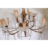 A brass twelve light two tier chandelier with glass shades, 22" diameter, 15" drop