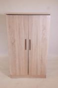 A limed oak style two door cupboard, 30½" x 21", 50" high