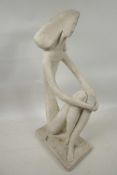 An abstract pottery figure of a seated lady, 11" high