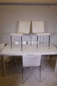 A white lacquered table and six leather chairs raised on chromed supports, table 66" x 32" x 30"