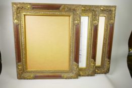 A set of three moulded and parcel gilt picture frames, containing prints of female nudes, 16" x