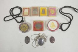 A collection of Tibetan and Thai votive pendants and icons, largest 2½"