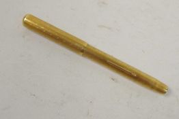 A rolled gold 'purse' fountain pen, with 9ct gold nib, 4" long
