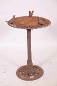 A Victorian cast iron bird bath with a pierced rim surmounted by three birds, 31" high x 20"