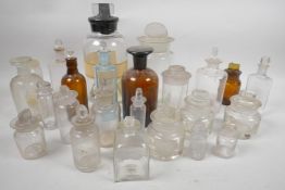 A quantity of glass jars and bottles with glass stoppers, largest 9" tall