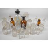 A quantity of glass jars and bottles with glass stoppers, largest 9" tall