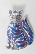 A silver and plique a jour brooch modelled as a seated cat, 1½" long