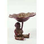 A Chinese bronze bowl designed as a seated boy holding a lotus leaf with frog, 2" high