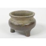 A miniature bronze censer on three feet, 4 character mark to base, 2" diameter