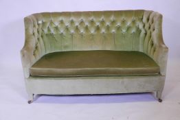 An early C20th tub shaped two seater settee with shaped ends and button back upholstery, 52" wide,