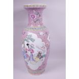 A large Chinese Republic period famille rose vase decorated with panels illustrating figures in a