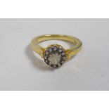 A silver gilt ring set with an Indian uncut diamond encircled by smaller diamonds, approximate