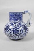 A Chinese blue and white porcelain Ming style jug with scrolling lotus flower decoration, 4