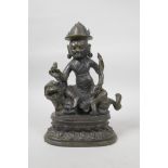 A Sino-Tibetan bronze of a wrathful spirit riding a tiger, 10½" high