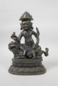 A Sino-Tibetan bronze of a wrathful spirit riding a tiger, 10½" high