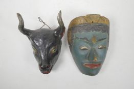 An Indian painted wood mask of a green skinned deity and another in the form of a bull's head,