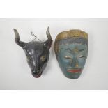 An Indian painted wood mask of a green skinned deity and another in the form of a bull's head,