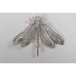 A 925 silver dragonfly brooch set with emerald panels, 2" long
