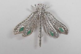 A 925 silver dragonfly brooch set with emerald panels, 2" long