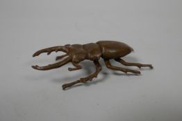 A Japanese Jizai style bronze of a beetle, indistinct impressed marks to base, 3" long