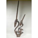 An African carved wood figure of two stylised antelope, 39" high