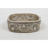 A Chinese white metal filigree bangle, impressed 2 character mark to interior, 2" x 2½"