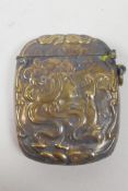 A brass vesta case with repousse Art Nouveau style decoration, 1½" x 2"