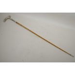 A Malacca riding crop with spiral bound shaft and white metal handle, 27½" long