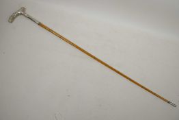 A Malacca riding crop with spiral bound shaft and white metal handle, 27½" long