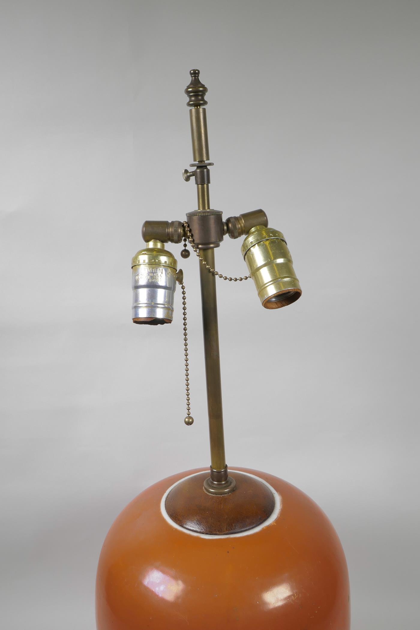 An Oriental coral glazed porcelain lamp with brass fittings on a hardwood base, 26" high - Image 2 of 2