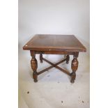 An oak drawleaf dining table, raised on turned bulbous supports, 36" x 36"