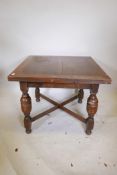 An oak drawleaf dining table, raised on turned bulbous supports, 36" x 36"