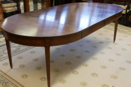 An American cherrywood draw leaf dining table raised on square tapering supports, with two leaves,