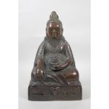 A Tibetan bronze of a bearded deity/figure seated in meditation, 12" high