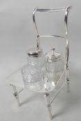 A novelty three piece glass and silver plate cruet set in an unusual stand modelled as a bar back