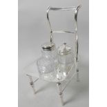 A novelty three piece glass and silver plate cruet set in an unusual stand modelled as a bar back