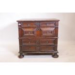 A C17th Jacobean oak garret chest of two over two drawers, with moulded fronts and brass drop hand