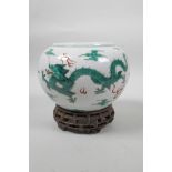 A late C19th/early C20th Chinese famille verte porcelain bowl decorated with green enamel dragons