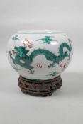 A late C19th/early C20th Chinese famille verte porcelain bowl decorated with green enamel dragons